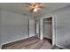 This is a bright bedroom with a closet and wood laminated floors at 16112 N 15Th St, Lutz, FL 33549