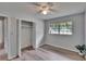 Inviting bedroom with wood-look floors, ceiling fan, large window, and a closet space at 16112 N 15Th St, Lutz, FL 33549