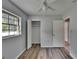 Bright bedroom features a large window, ceiling fan, and closet for storage at 16112 N 15Th St, Lutz, FL 33549