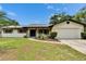 Charming single-story home featuring a well-maintained lawn, welcoming front entry, and attached two-car garage at 16112 N 15Th St, Lutz, FL 33549