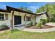 Inviting front entry featuring a double door entry, decorative pillars, tasteful landscaping, and a 'Welcome' sign at 16112 N 15Th St, Lutz, FL 33549