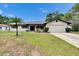 Charming single-story home featuring a 2-car garage, a well-manicured lawn and mature landscaping at 16112 N 15Th St, Lutz, FL 33549