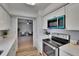 Contemporary kitchen boasting white cabinets, stainless steel oven and microwave, flowing into living space at 16112 N 15Th St, Lutz, FL 33549