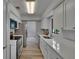 Bright kitchen features stainless steel appliances, white cabinets, and light countertops at 16112 N 15Th St, Lutz, FL 33549