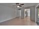 Spacious living room with neutral walls, tile flooring, ceiling fan and a seamless transition to the kitchen and dining area at 16112 N 15Th St, Lutz, FL 33549