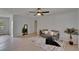 Comfortable living room featuring a neutral color palette and a stylish ceiling fan at 16112 N 15Th St, Lutz, FL 33549