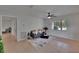 Bright living room with neutral walls, tile flooring, ceiling fan, and a large window providing plenty of natural light at 16112 N 15Th St, Lutz, FL 33549