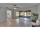 Bright room features tiled floors, a ceiling fan, and sliding glass doors to a screened-in patio at 16112 N 15Th St, Lutz, FL 33549