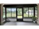 Enclosed porch features windows for serene outdoor views and a door for easy access at 16112 N 15Th St, Lutz, FL 33549