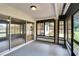 Enclosed back porch with views of the yard, has sliding doors to interior at 16112 N 15Th St, Lutz, FL 33549