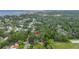 Aerial view of the tree-lined neighborhood with mature greenery near the bay, showcasing the property's location at 1753 San Mateo Dr, Dunedin, FL 34698
