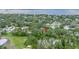 An aerial view of a property, surrounded by mature trees and greenery near the water, highlighting the neighborhood's landscape at 1753 San Mateo Dr, Dunedin, FL 34698