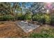 Spacious backyard features mature trees and vegetation, plus a quaint deck with outdoor seating at 1753 San Mateo Dr, Dunedin, FL 34698