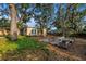 Backyard featuring a wooden deck, patio furniture, and mature trees at 1753 San Mateo Dr, Dunedin, FL 34698