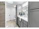Bright bathroom features gray cabinets, a white countertop, modern finishes and decor at 1753 San Mateo Dr, Dunedin, FL 34698