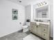 Stylish bathroom featuring a vanity with a marble countertop and decorative artwork at 1753 San Mateo Dr, Dunedin, FL 34698