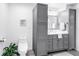 Bathroom featuring gray cabinets, toilet, white countertop, and decor at 1753 San Mateo Dr, Dunedin, FL 34698
