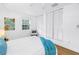 Bedroom features white walls, wood floors, a window, and closet at 1753 San Mateo Dr, Dunedin, FL 34698