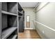 Walk-in closet features built-in shelving and wood floors at 1753 San Mateo Dr, Dunedin, FL 34698