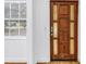 Beautiful glass paneled wooden front door and a large window that offers natural light at 1753 San Mateo Dr, Dunedin, FL 34698