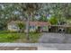 Charming single-story home with mature landscaping and a covered carport at 1753 San Mateo Dr, Dunedin, FL 34698