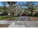 Charming single-story home features a large driveway, carport, mature landscaping and mature shade trees at 1753 San Mateo Dr, Dunedin, FL 34698