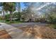 Charming single-story home features a large driveway, carport, mature landscaping and mature shade trees at 1753 San Mateo Dr, Dunedin, FL 34698