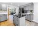 Open kitchen design with grey cabinetry, stainless appliances, granite island and views to the living room at 1753 San Mateo Dr, Dunedin, FL 34698