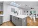 An airy kitchen with white countertops and cabinetry features an open design with natural light at 1753 San Mateo Dr, Dunedin, FL 34698
