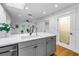 An airy kitchen with white cabinets, quartz countertops, stainless steel appliances, and a door to pantry at 1753 San Mateo Dr, Dunedin, FL 34698