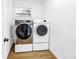 Well-lit laundry room with modern washer and dryer for efficient home management at 1753 San Mateo Dr, Dunedin, FL 34698