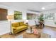 Living room featuring a comfortable yellow sofa, neutral rug, accent furniture, and lots of light at 1753 San Mateo Dr, Dunedin, FL 34698
