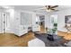 Open living area with white armchairs, stylish decor, wood floors, and white trim at 1753 San Mateo Dr, Dunedin, FL 34698