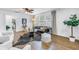 Bright living room featuring modern decor, hardwood floors, and bright natural light from multiple windows at 1753 San Mateo Dr, Dunedin, FL 34698