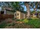 Backyard featuring a storage shed, mature trees, and lush greenery at 1753 San Mateo Dr, Dunedin, FL 34698
