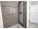 Walk-in shower featuring neutral tile surround, modern showerhead, and built-in niche at 1753 San Mateo Dr, Dunedin, FL 34698