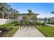 Community amenities including a bike rack, lush landscaping, and a charming poolside covered lounge area at 17881 Star Ruby Pl, Nokomis, FL 34275
