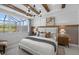Tranquil bedroom with beamed ceiling, chandelier, neutral decor, and a view of the outdoor living space at 17881 Star Ruby Pl, Nokomis, FL 34275