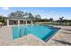 Relaxing community pool with an adjacent covered lounge area, ideal for unwinding and socializing at 17881 Star Ruby Pl, Nokomis, FL 34275