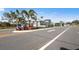 Entrance to Legacy Groves community with lush landscaping, street and signage at 17881 Star Ruby Pl, Nokomis, FL 34275