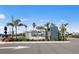 Well-maintained community entrance with Legacy Groves sign and tropical landscaping at 17881 Star Ruby Pl, Nokomis, FL 34275