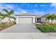 Charming single-story home with a paver driveway, two-car garage and well-maintained landscaping with palm trees at 17881 Star Ruby Pl, Nokomis, FL 34275