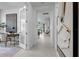 Open hallway leading to the main living area, featuring tile floors and decorative wall art at 17881 Star Ruby Pl, Nokomis, FL 34275