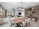 Spacious living room with designer furniture, neutral tones, a large window with a scenic view, and accent shelving at 17881 Star Ruby Pl, Nokomis, FL 34275