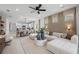 Open-concept living area with sleek furniture, modern lighting, connecting dining and kitchen, and ample natural light at 17881 Star Ruby Pl, Nokomis, FL 34275