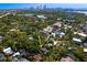 Aerial view of neighborhood, property indicated by arrow, with Tampa skyline in distance and plenty of trees at 1805 W Jetton Ave, Tampa, FL 33606