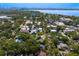 Aerial view of neighborhood, surrounding water, and mature trees on a sunny day at 1805 W Jetton Ave, Tampa, FL 33606