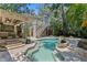 Backyard view showcasing the pool, outdoor living space, and lush landscaping at 1805 W Jetton Ave, Tampa, FL 33606