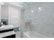Remodeled bathroom with glass shower, marble walls, and soaking tub, offering a spa-like experience at 1805 W Jetton Ave, Tampa, FL 33606