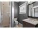 Gray bathroom featuring a glass enclosed shower, dark wood vanity, and tiled floors at 1805 W Jetton Ave, Tampa, FL 33606